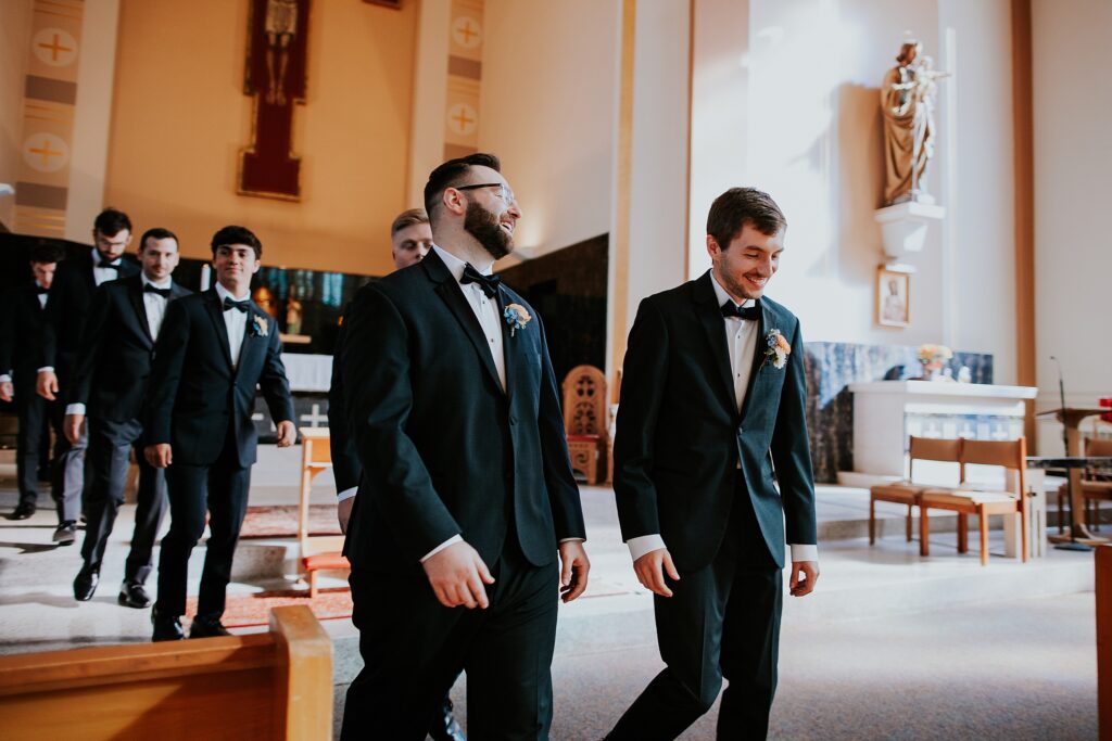 The groom and his groomsmen walking into their places before the ceremony